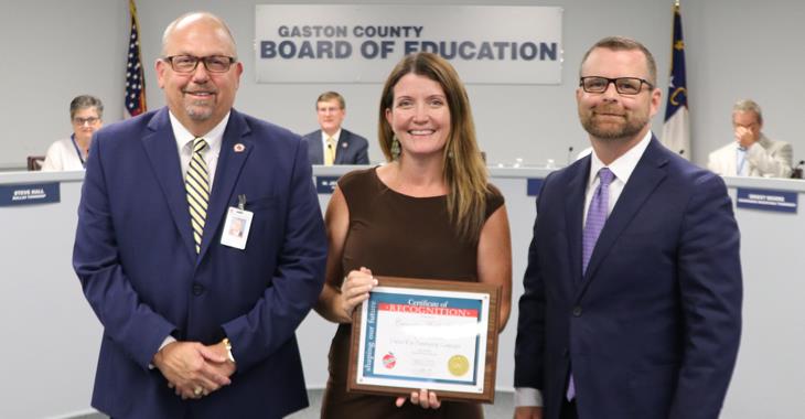 Cramerton Middle School assistant principal Beth Crosby pictured with Board Chairman Jeff Ramsey and school principal Kevin Doran.